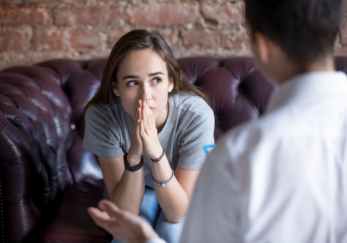 A woman talking with a counselor, discussing How to Calm Anxiety