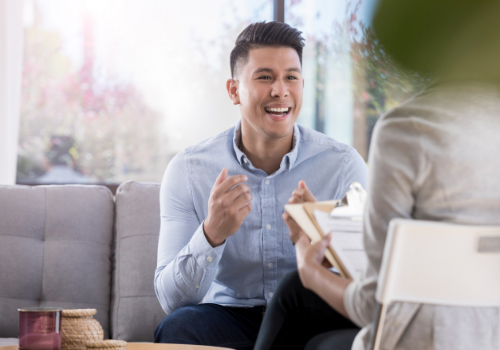 A happy man talking with counselor after successful Stress Management Therapy in Peoria IL