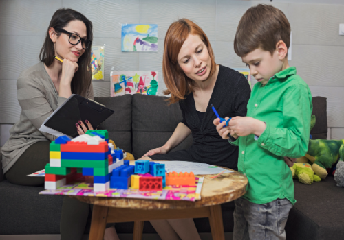 A counselor and parent interacting with a child during Children and Teen Counseling in Peoria IL