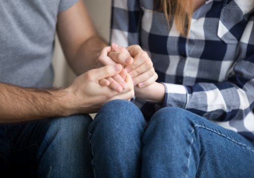 Two partners holding hands during Couples Therapy in Dunlap IL