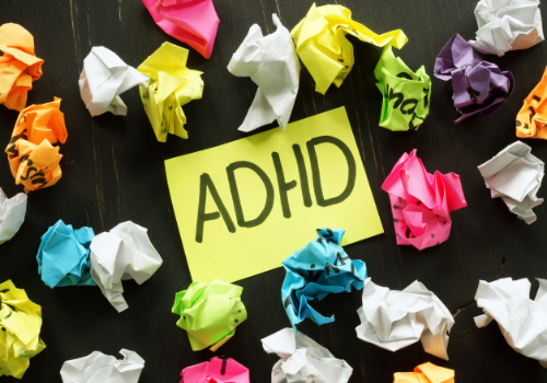 A bunch of crumpled up notes, with one that says ADHD