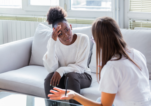 Sad woman talking with counselor during Depression Therapy in Peoria IL