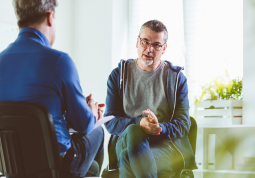 Man talking with a therapist about Men's Issues in Peoria IL
