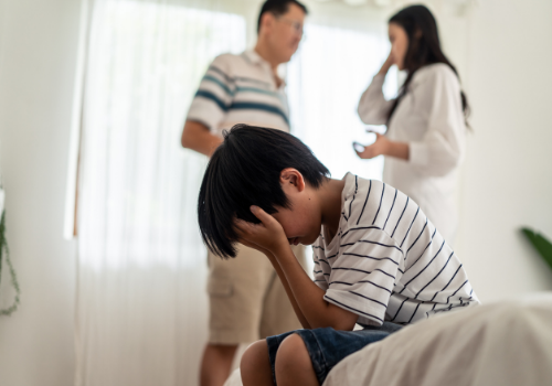 A sad child with arguing parents needing Parenting Allocation Evaluations in Peoria IL