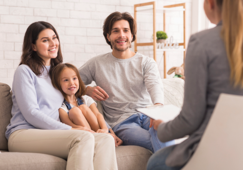Happy family listening to therapist during Family Therapy Near You