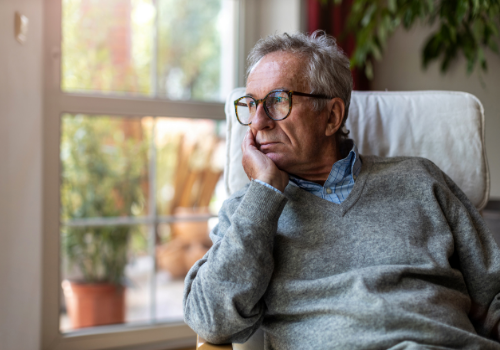 Depression Treatment Washington IL 1 A man sadly looking out the window and contending with depression, needing Depression Treatment in Washington IL