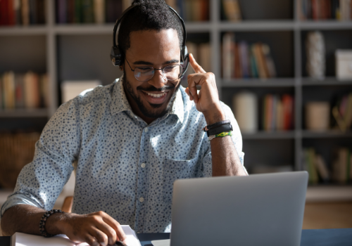 A happy man talking with their therapist on the computer during Telehealth Counseling in Washington IL