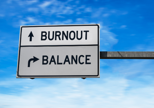 A road sign pointing to burnout and also leading to "balance" for Burnout Treatment in Peoria IL