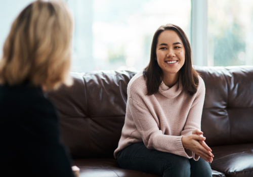 A happy woman smiling and agreeing with her counselor during Peoria Counseling Services