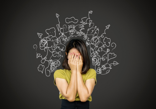 A woman holding her hands to her face, having trouble with Stress Management in Peoria IL
