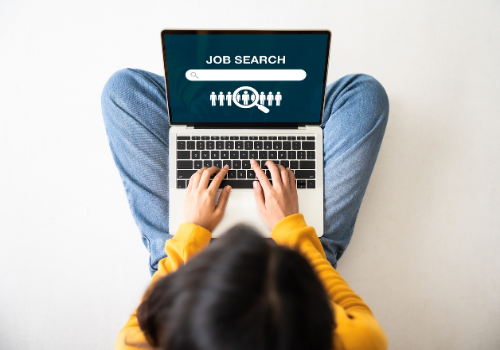 A woman on a laptop, job searching and looking for a Career Change in Peoria IL