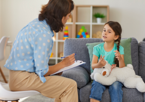 A counselor working with a child and discussing her ADHD and Learning Problems in Peoria IL