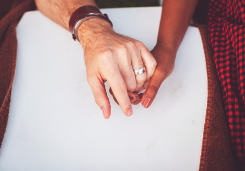 A happy couple holding hands after Couples Counseling Near You