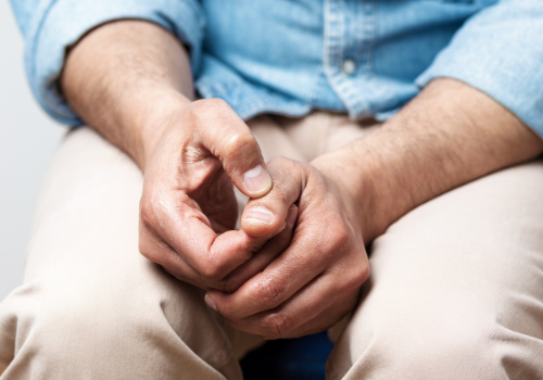 Man feeling anxious and picking at finger nails, needing Anxiety Therapy in Peoria IL