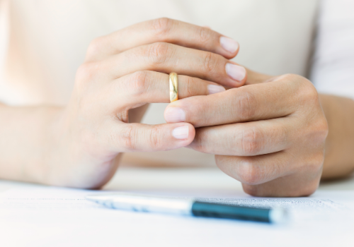 Spouse taking off ring after participating in Divorce and Family Mediation in Peoria IL