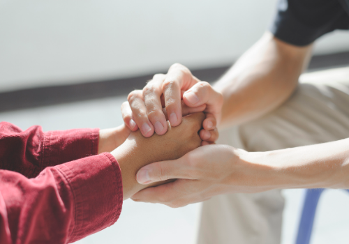 Counselors in East Peoria IL holding the hands of their client