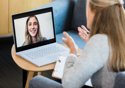 A counselor talking with their client via computer during Peoria Telehealth Counseling