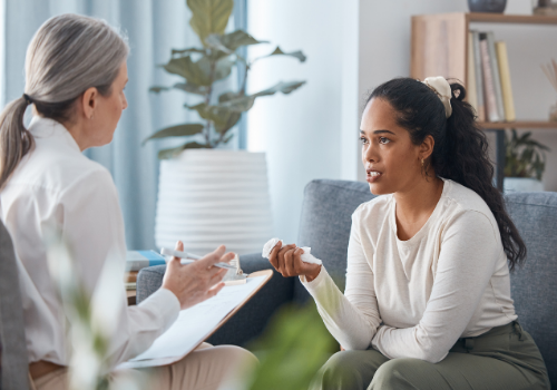 A woman talking with a counselor, discussing Women's Issues in Peoria IL