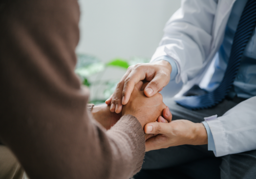 Counselor comforting client by holding their hands during Counseling in East Peoria IL