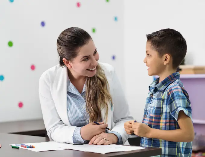 A female psychologist performing an ADHD assessment with a young boy, part of the psychological testing and assessments performed by Chapin & Russell Associates.