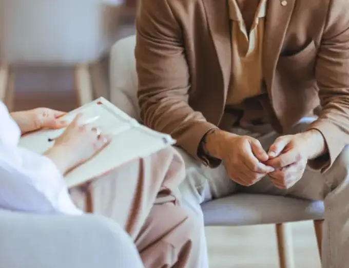 A man experiencing anxiety talking with a trained mental health professional as a part of counseling services from Chapin & Russell Associates